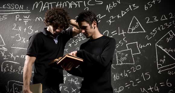 Students in front of a chalkboard.